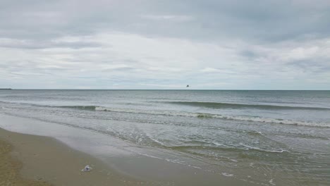 Great-Egret-Flies-Across-the-Cha-Am-Beach-Ocean-Waves-in-Thailand