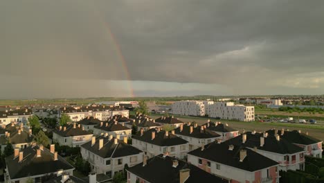 Rainbow-With-Gloomy-Sky-Over-Residential-Neighborhoods-Near-Szczecin-City-In-Poland