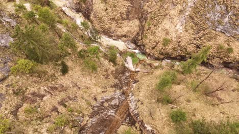 Aerial-view-of-the-Almbachklamm-waterfall-in-Garmisch-Partenkirche-during-summer-showcases-the-vibrant-display-of-colorful-foliage