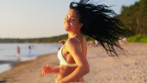 Young-Woman-in-Bikini-Swimsuit-Running-on-Beach.people,-summer-and-swimwear-concept-young-woman-in-bikini-swimsuit-on-beach