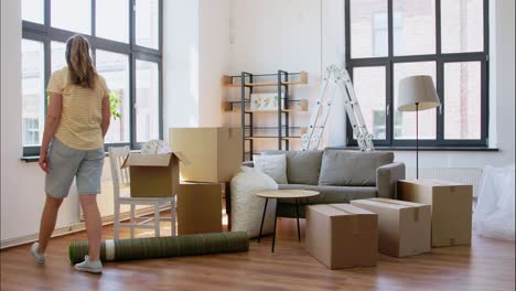 Women-with-Adhesive-Tape-Packing-Boxes-at-Home.moving,-people-and-real-estate-concept-women-with-adhesive-tape-packing-boxes-at-home