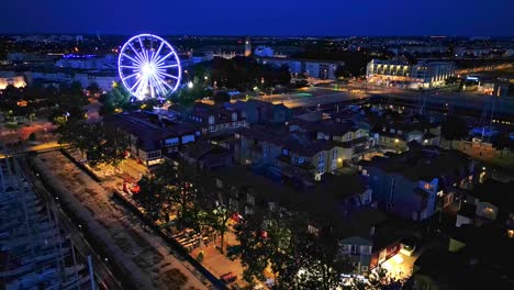 The-old-port-near-Quai-Valin-with-big-wheel-at-night,-La-Rochelle,-France