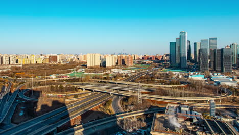 Avenue-City-highway-crossroad-traffic-flow-landscape-sunrise-morning-scene-near-small-lake-river,-Time-Lapse-Heavy-traffics-jam-cars-flowing-at-open-hour-business