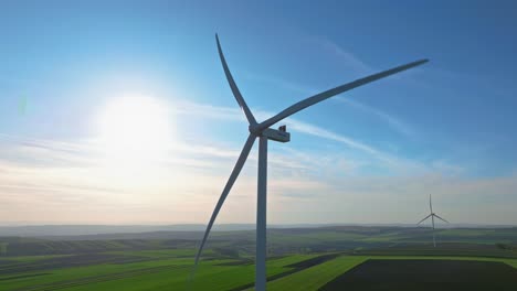 Wind-turbine-spinning-on-a-sunny-day-in-a-green-field