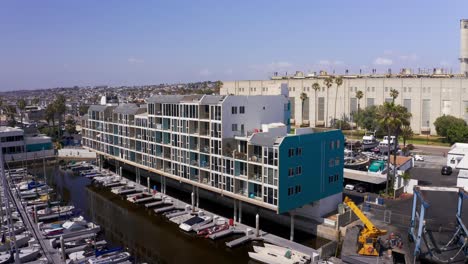 Aerial-reverse-pullback-rising-shot-of-the-residential-apartments-at-King-Harbor-Marina-in-Redondo-Beach,-California