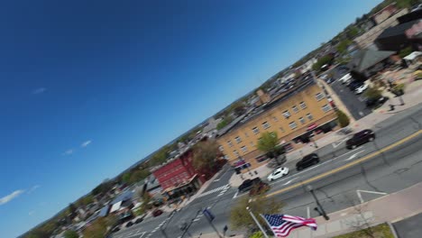 Speed-flight-over-american-city-with-main-street-in-summer