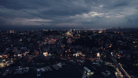 Drone-shot-of-Istanbul-at-night,-view-on-the-Kariye-Mosque,-Cami-and-Eminönü-area,-slow-motion-and-copy-space