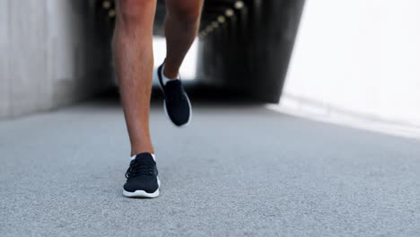 Legs-of-Young-Man-Running-Out-of-Tunnel.fitness,-sport-and-healthy-lifestyle-concept-legs-of-young-man-running-out-of-tunnel