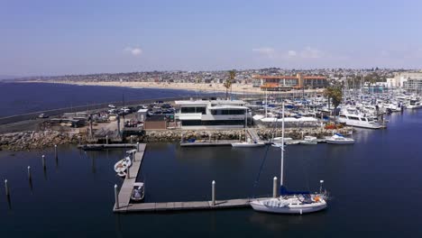 Panning-close-up-aerial-shot-of-the-King-Harbor-Yacht-Club-in-Redondo-Beach,-California