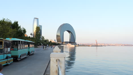 People-and-Tourist-Train-on-Boardwalk,-Baku-City-at-Caspian-Sea-STATIC