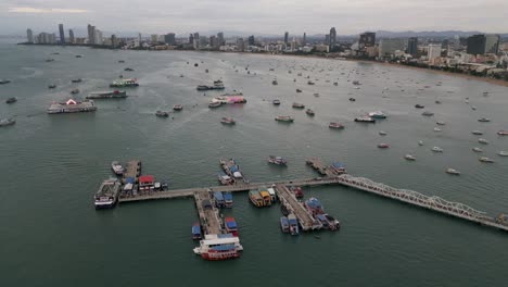 Vista-Aérea-Del-Horizonte-De-La-Ciudad-De-Pattaya,-Camino-De-Playa-Y-Calle-Peatonal-Con-Muelle-De-Puerto-Para-Barco-Rápido-A-La-Isla-De-Ko-Lan,-Destino-De-Vacaciones-En-Tailandia