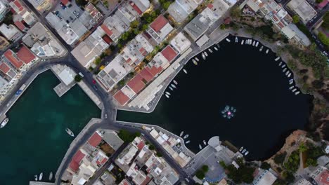 Aerial-Top-View-over-Voulisméni-Lake-in-Agios-Nikolaos-Town,-Crete,-Greece