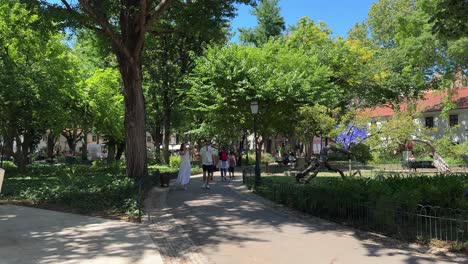 People-stroll-and-take-photos-along-the-park-at-Amoreiras-Garden-in-Lisbon,-Portugal