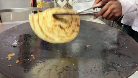 Close-up-shot-of-a-man-preparing-lacha-paratha-at-a-shop-in-India