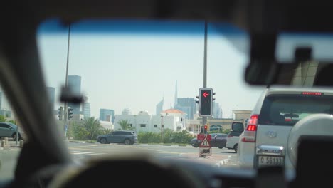 Shot-of-vehicles-waiting-on-a-Traffic-signal-on-a-busy-street-of-Dubai-in-United-Arab-Emirates