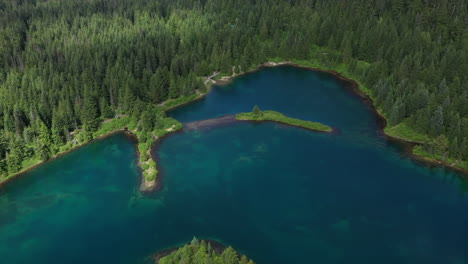 Turquoise-Lake-Nestled-in-a-Mountain-Valley-Aerial-Orbit-Drone-View