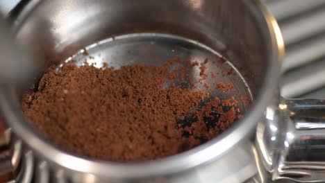 Freshly-ground-coffee-beans,-coffee-grinding-process-close-up