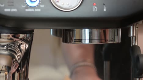 Barista-puts-holder-from-coffee-machine,-espresso-making