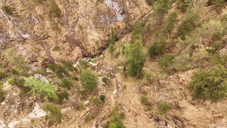 Aerial-view-of-the-Almbachklamm-waterfall-in-Garmisch-Partenkirche-during-summer-showcases-the-vibrant-display-of-colorful-foliage