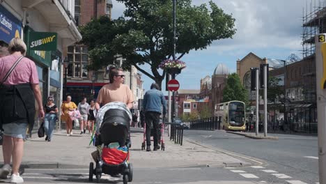 footage-of-Scarborough-town-centre,-North-Yorkshire-on-a-summer-day-on-a-busy-weekend-with-families-and-couples-walking-around-the-shops-in-the-town