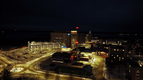 Aerial-view-approaching-the-Central-hospital-of-Vaasa,-winter-night-in-Finland