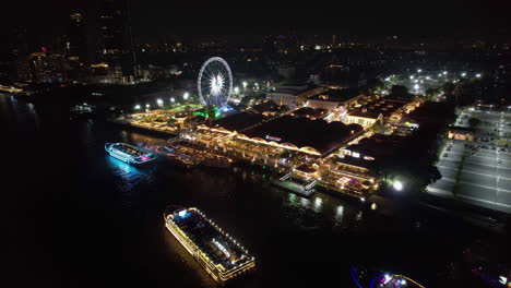 Vista-Aérea-Desde-La-Orilla-Del-Río-Asiatique,-De-Noche-En-Bangkok,-Tailandia