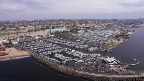 Wide-descending-aerial-shot-of-the-King-Harbor-Yacht-Club-in-Redondo-Beach,-California