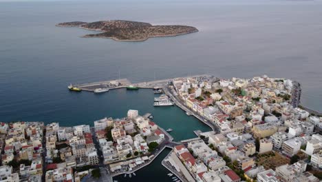 Aerial-of-Agios-Nikolaos-Center-Town,-Marine-Harbor,-Voulisméni-Lake-and-Agioi-Pantes-Islet,-Crete,-Greece