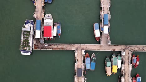 aerial-top-down-of-pier-in-pattaya-with-tourist-boarding-the-boat-for-visiting-Ko-Lan-island-gulf-of-Thailand