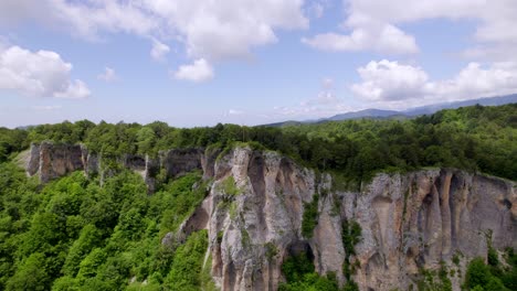 Drone-video-showing-a-cross-on-a-forested-mountain-in-Georgia,-Europe