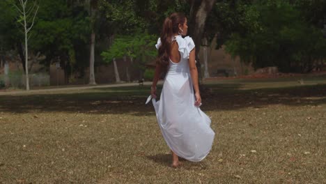 A-young-girl-in-a-white-outfit-relishes-a-sunny-day-at-the-Botanical-Gardens-on-the-island-of-Trinidad-in-the-Caribbean