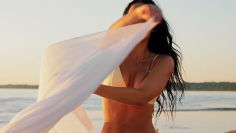 Woman-in-Bikini-Swimsuit-with-Pareo-on-Beach.people,-summer-and-swimwear-concept-happy-smiling-young-woman-in-bikini-swimsuit-with-pareo-on-beach