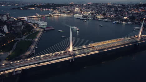 Blue-hour-night-shot-on-the-bosphorous-showing-the-golden-horn-bridge-and-the-main-river-of-Istanbul,-copy-space-and-slow-motion