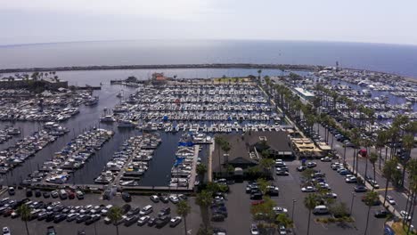 Low-aerial-dolly-shot-of-the-King-Harbor-Marina-looking-out-towards-the-Pacific-Ocean-in-Redondo-Beach,-California