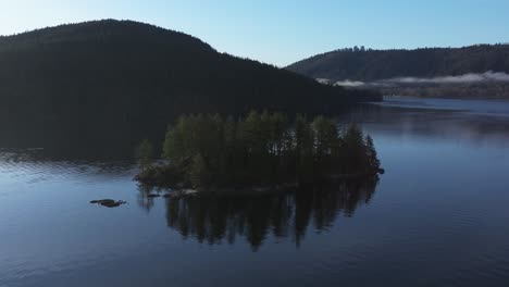 Rotating-shot-of-a-tree-covered-island-in-the-Indian-Arm-of-Vancouver-British-California