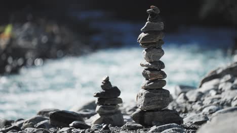 A-picturesque-scene-of-carefully-arranged-rocks,-symbolizing-harmony-and-peacefulness-by-a-river