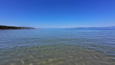 Slow-motion-landscape-view-of-sandy-ocean-bay-cove-water-inlet-coastline-shore-headland-of-Greece-Europe-Mediterranean-Sea-travel-holiday-destination-outdoors