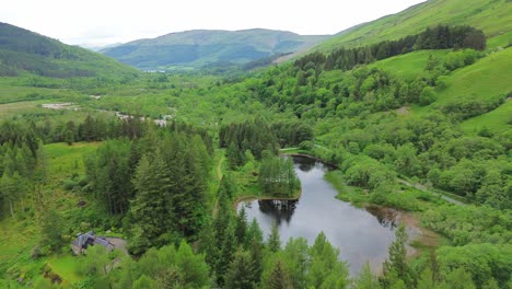 Drone-flight-over-the-forest-in-Glencoe-mountains,-Scotland