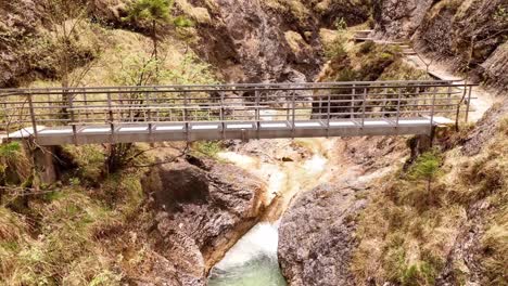 Aerial-view-of-the-Almbachklamm-waterfall-in-Garmisch-Partenkirche-during-summer-showcases-the-vibrant-display-of-colorful-foliage