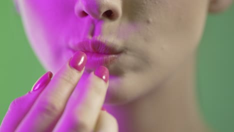 Close-Up-Of-Woman's-Mouth-Eating-Chewing-Marshmallow,-Colorful-Studio-Shot