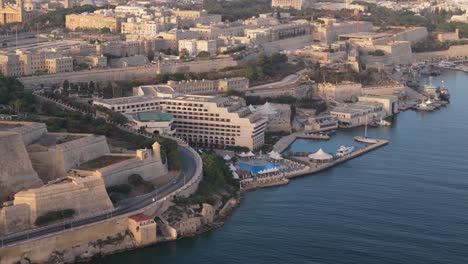 Luxury-resort-on-the-coast-line-of-Valletta,-Malta-with-ocean-front-pool