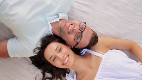 Happy-Couple-Lying-on-Picnic-Blanket.leisure,-vacation-and-people-concept-happy-couple-lying-on-picnic-blanket