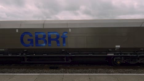 Freight-goods-cargo-train-passing-through-train-station-in-York,-United-Kingdom