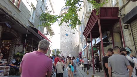 Crowded-pedestrian-area-just-below-the-Galata-Tower-in-Istanbul,-Turkey