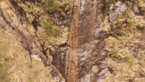 Aerial-view-of-the-Almbachklamm-waterfall-in-Garmisch-Partenkirche-during-summer-showcases-the-vibrant-display-of-colorful-foliage