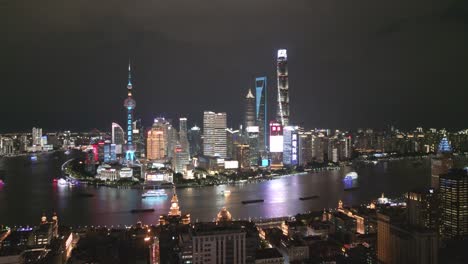 Aerial-Cityscape-of-Shanghai-China-Downtown,-night-illuminated-river-skyscrapers