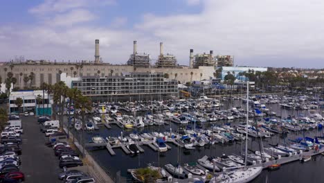 Aerial-low-reverse-pullback-shot-of-the-King-Harbor-Marina-in-Redondo-Beach,-California