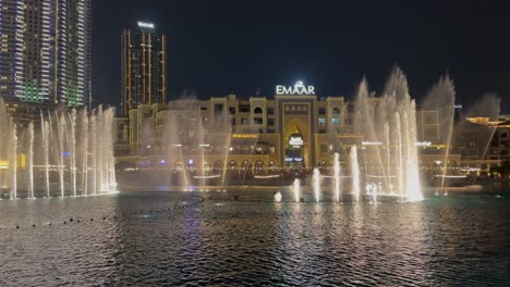 Evening-water-fountain-light-show-on-Burj-Khalifa-Lake-in-Dubai,-UAE