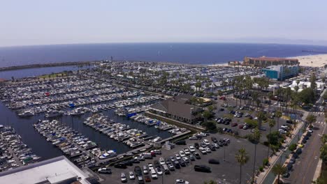 Low-panning-aerial-shot-of-the-King-Harbor-Marina-looking-out-towards-the-Pacific-Ocean-in-Redondo-Beach,-California