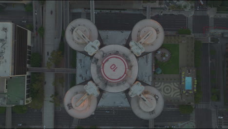 Ascending-aerial-view-of-the-Bonaventure-Hotel-in-Los-Angeles,-showcasing-the-layout-and-urban-environment-of-the-area